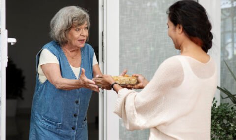 woman-offering-food-neighbor